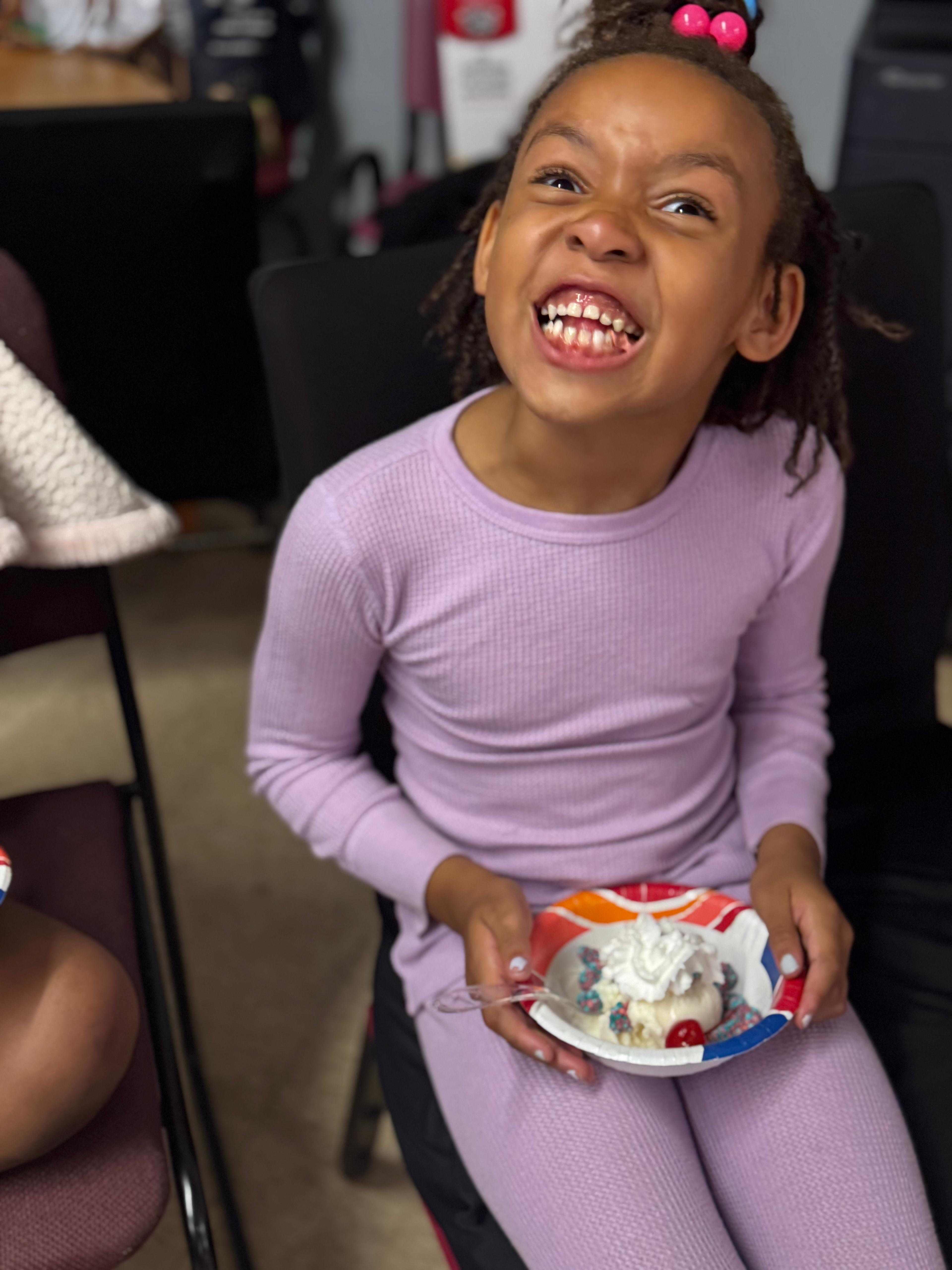 Pure joy — a camper beams with happiness during snack time