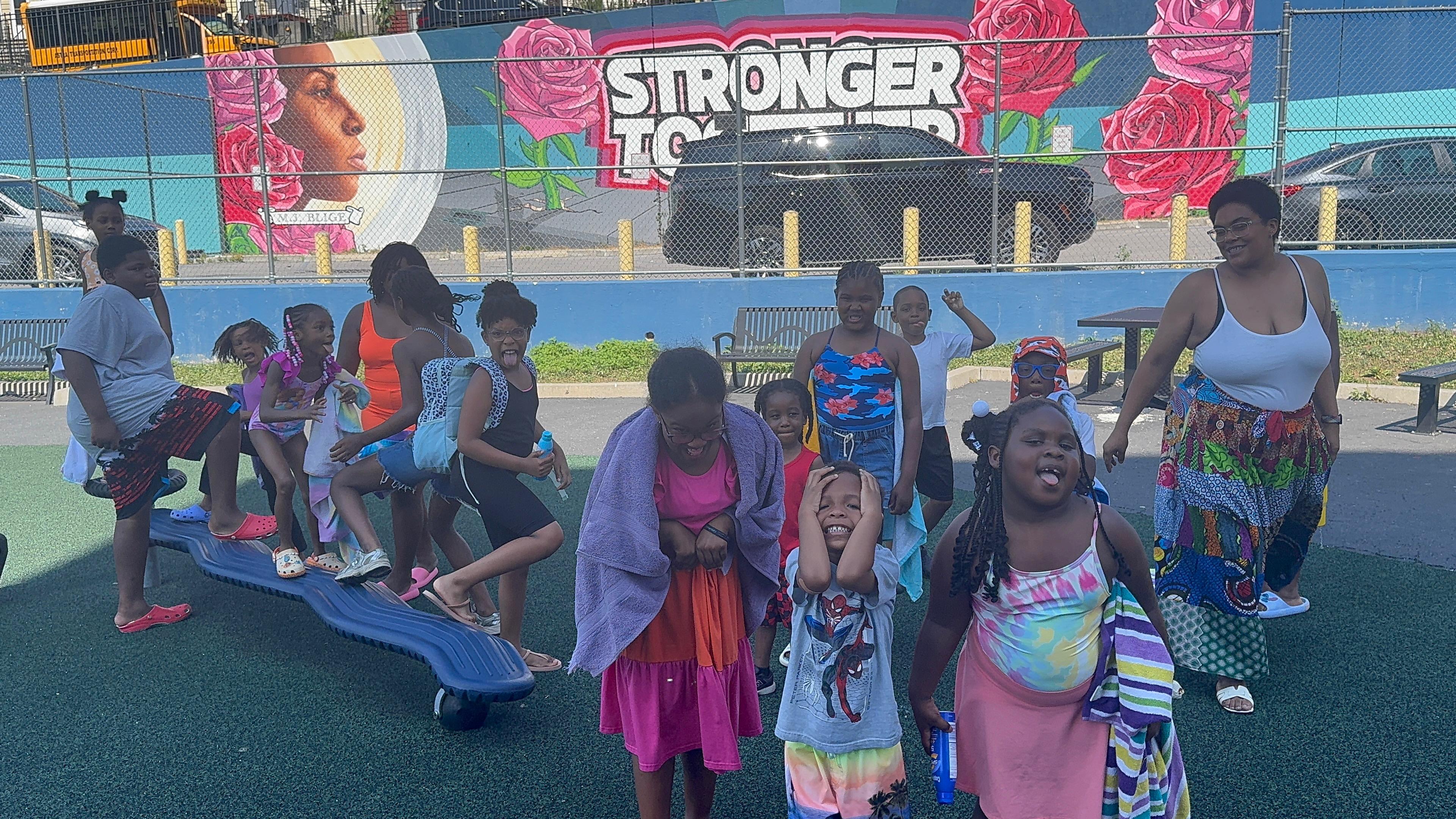 Outdoor fun at the park in front of the 'Stronger Together' mural