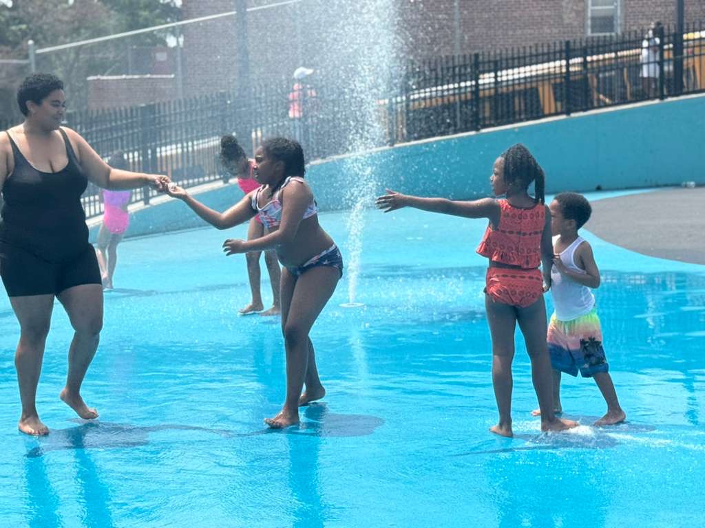 Splashing and playing at the outdoor splash pad on a summer day